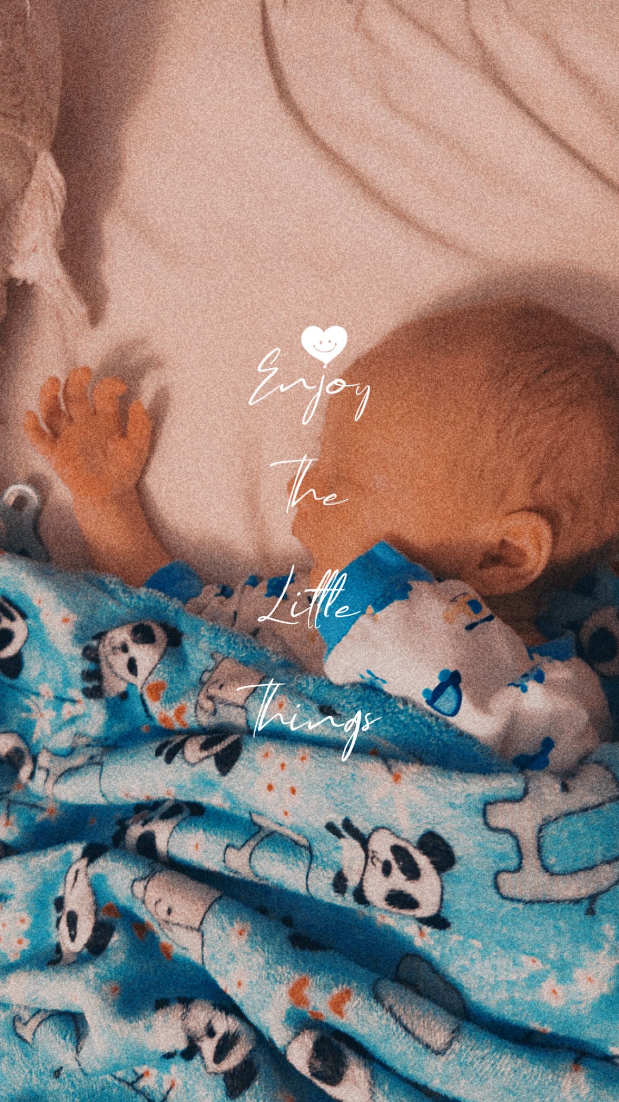 A newborn baby peacefully sleeping under a soft blue panda blanket with the words ‘Enjoy the little things’ overlayed on the image.